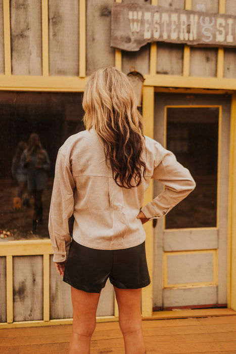Woman standing in front of a wooden building with 'Western & Co' sign.