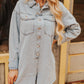 Woman wearing a light blue denim dress with a blurred background