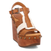 Brown wedge sandal with decorative strap and studs on a white background