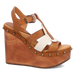 Brown wedge sandal with decorative straps on a white background