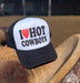 Trucker hat with 'I ❤️ HOT COWBOYS' text on a cowboy boot.