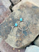 Two turquoise beaded bracelets on a textured stone surface