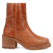 Brown leather boot with a block heel on a white background