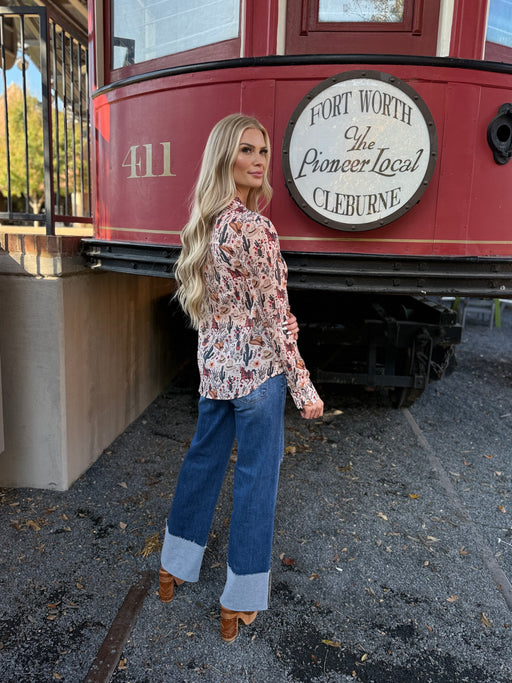 Woman standing in front of a red trolley with 'Fort Worth & Cleburne' branding.