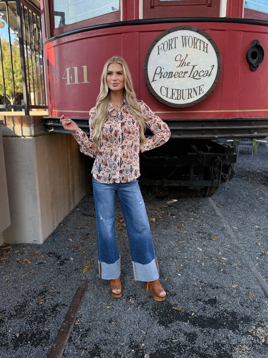 Woman posing in front of a red and white vintage-style vehicle with 'Fort Worth' branding.