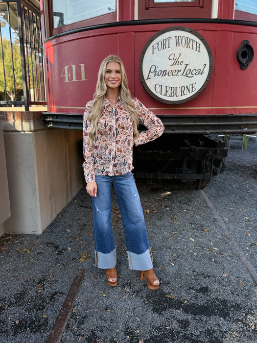 Woman standing in front of a red train with a sign that reads 'Fort Worth The Pioneer Local Cleburne'.