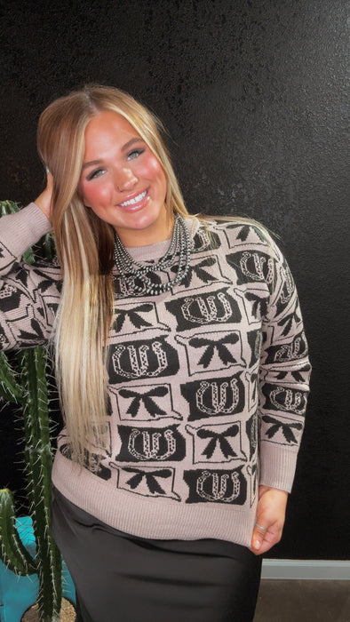 Woman wearing a patterned sweater with a black background